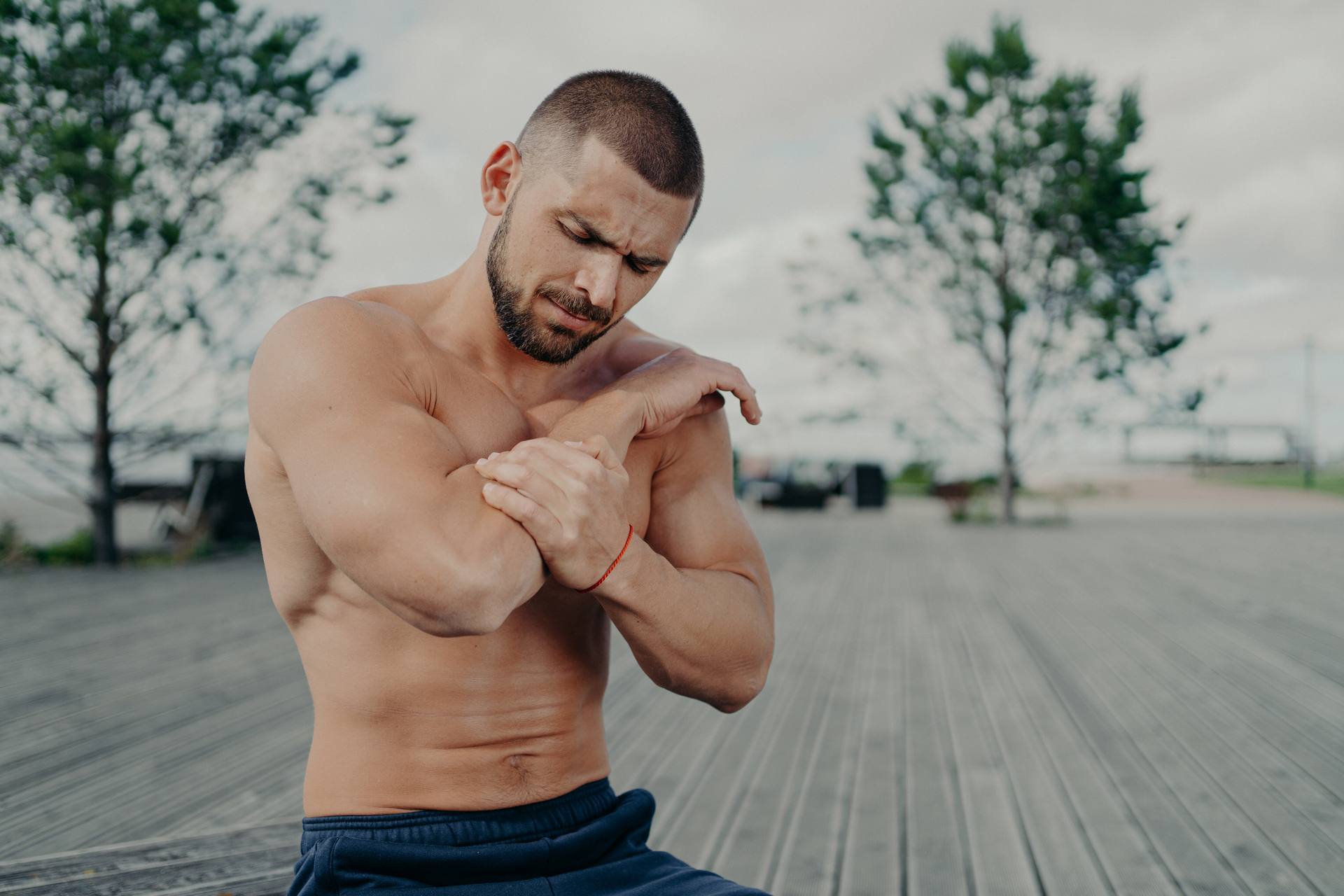 Man holding his injured arm