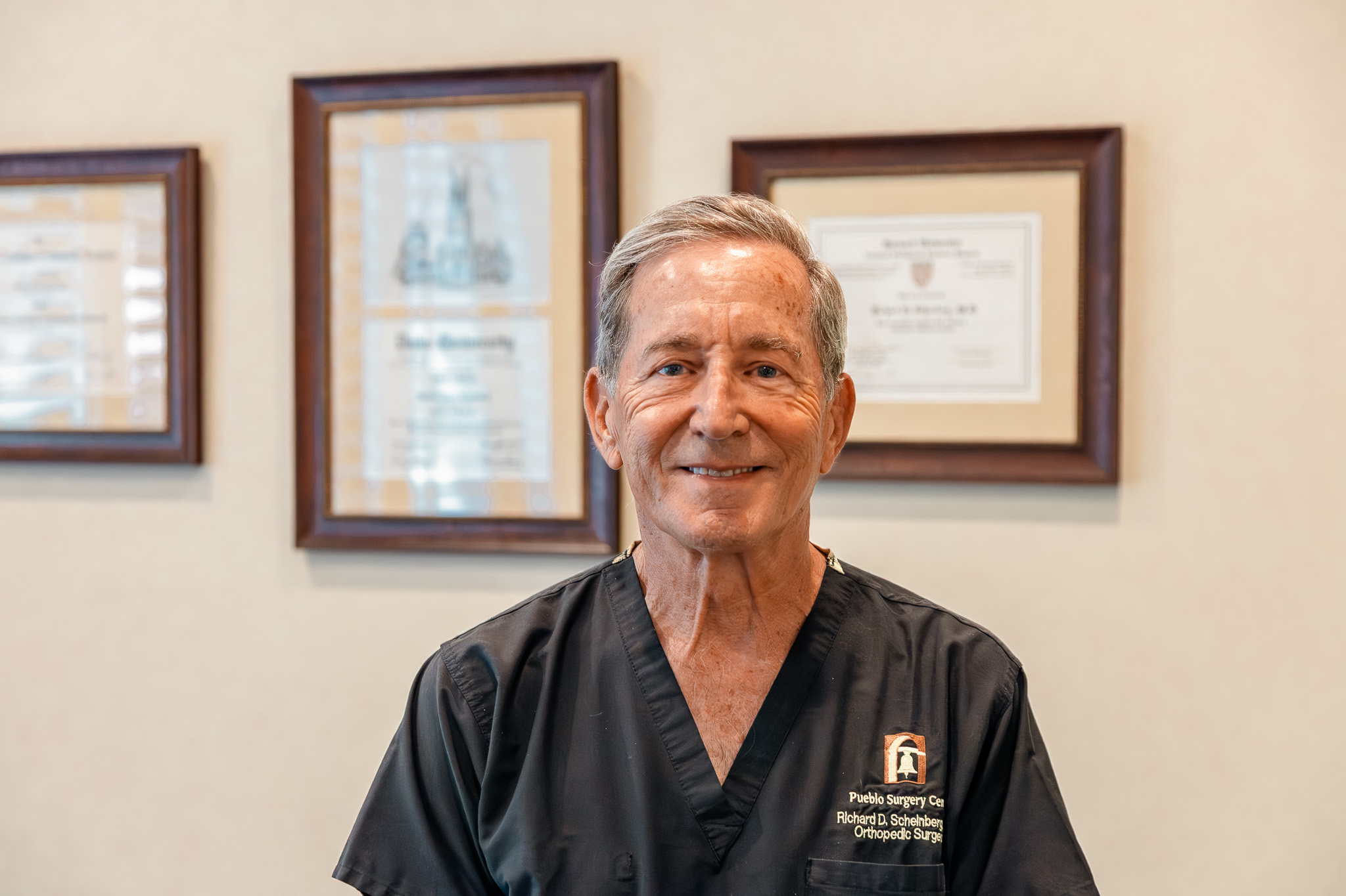 Dr. Richard Scheinberg in front of his diplomas