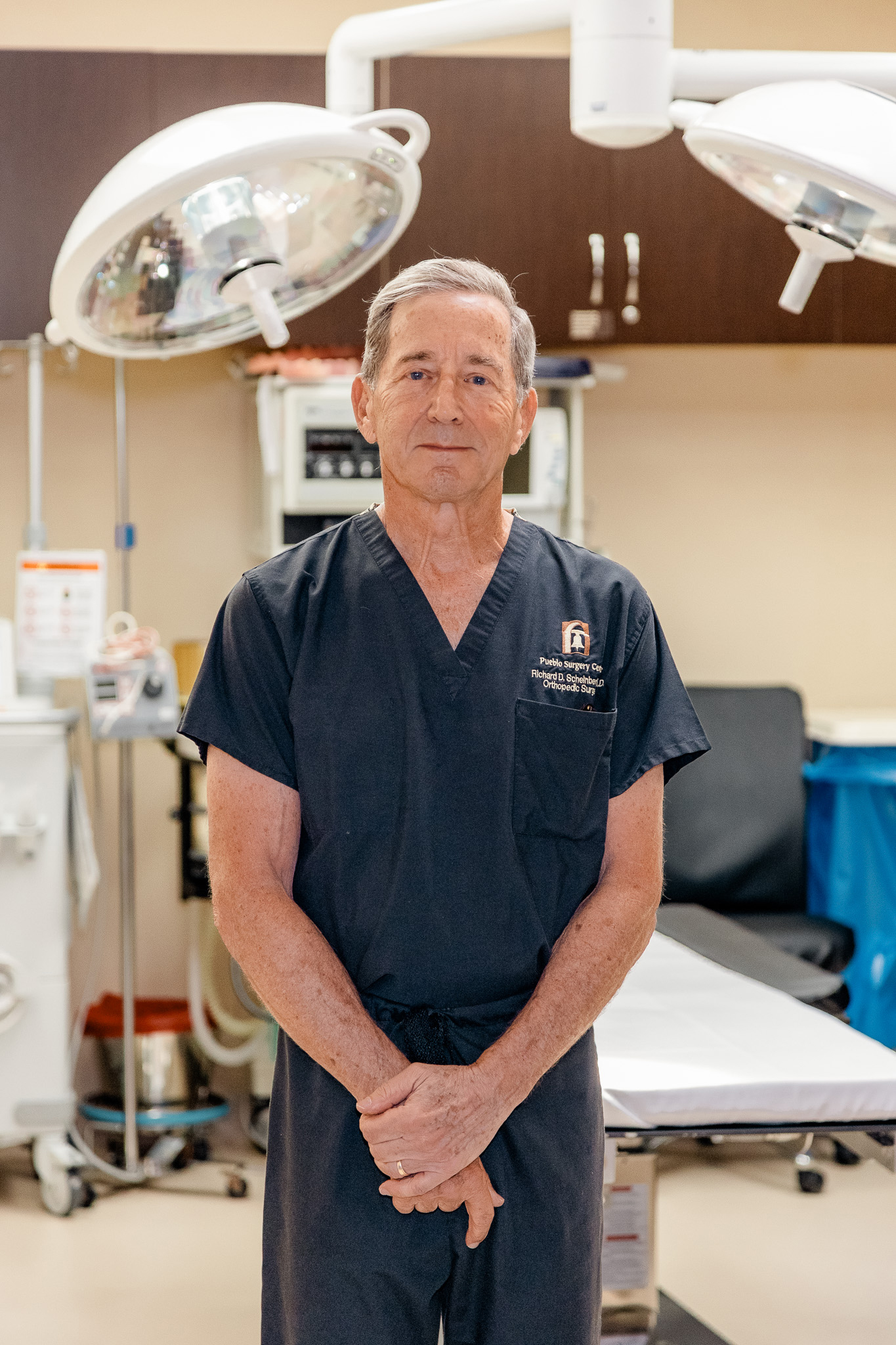 Dr. Scheinberg in scrubs under a procedure light