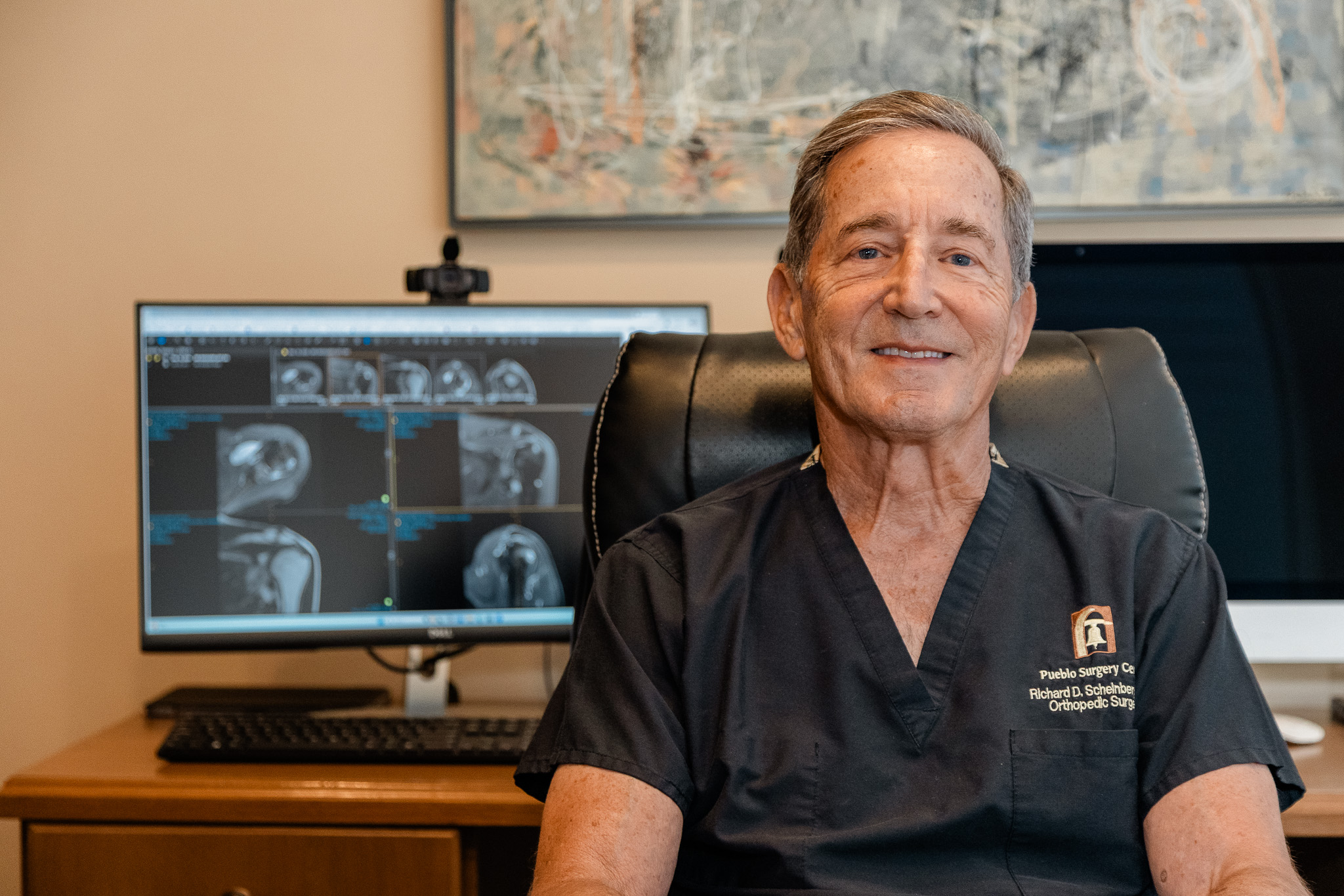 Dr. Scheinberg at his desk reviewing imaging